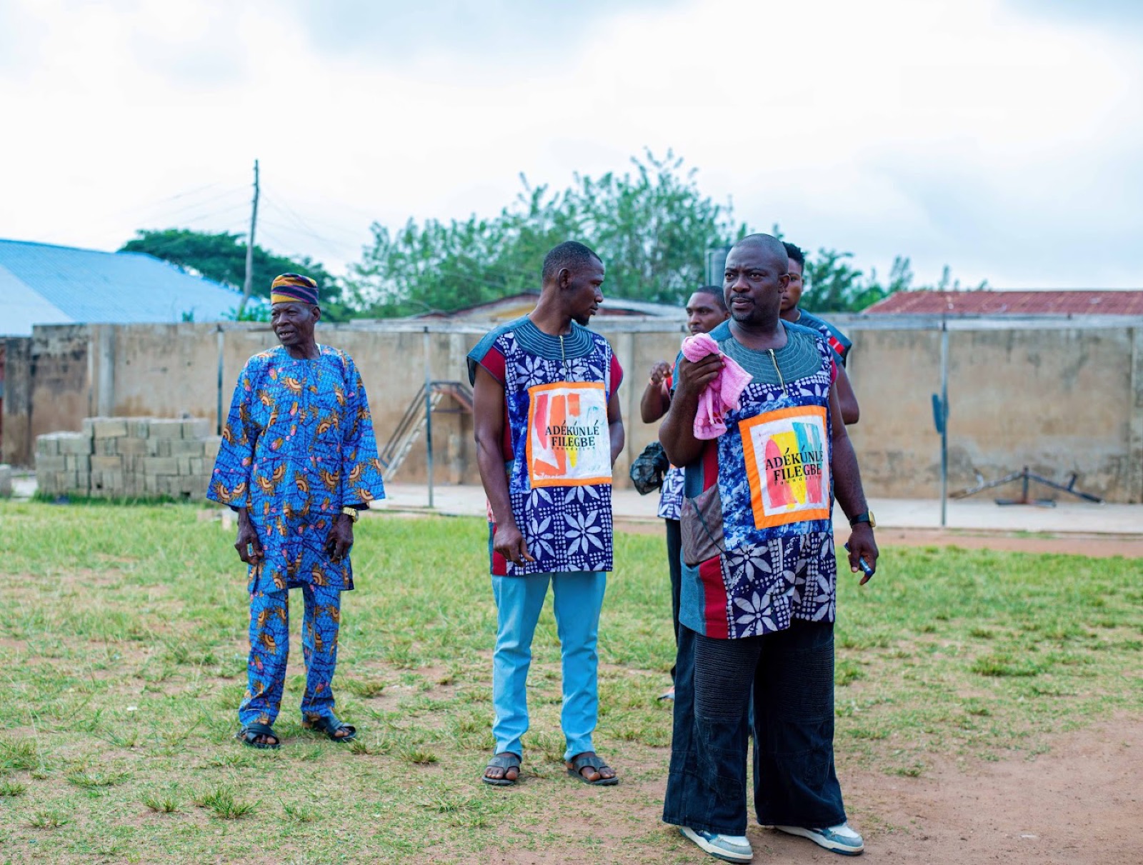 Men outdoors wearing vests printed with the foundation name.